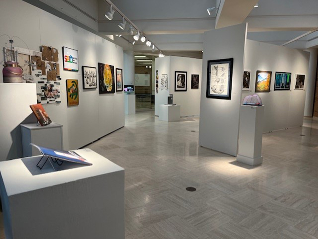 south end looking north in the student show with various works of art